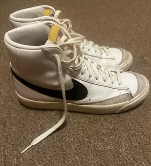 Nike White High-Top Sneakers with Black Swoosh and Yellow Tongue Tab thumbnail 1