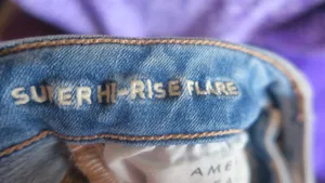 American Eagle Outfitters next level stretch super hi-rise flare jeans in medium wash blue size 4. thumbnail 14