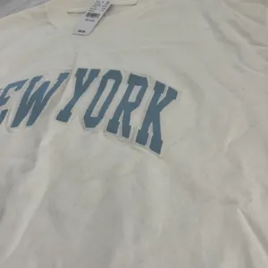 'new york' tee One Size Condition: NWT Color: white / blue Details : - See photos for approx. measurements laying flat - Boxy fit - Comfy - Easy to throw on Extras: - I ship between 1-2 days thumbnail 2