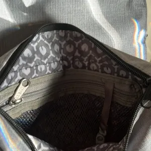 LL Bean purse in gray. The lighting is from the sun through the door. No stains thumbnail 2