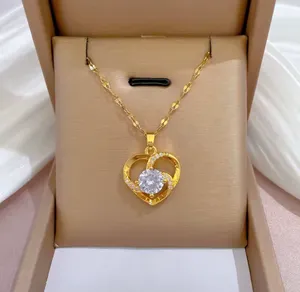 This elegant heart necklace is made from 18k gold-plated stainless steel and features a large central cubic zirconia stone surrounded by smaller crystal accents. thumbnail 2