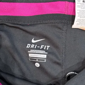 Nike Women’s Large DriFit Black with Pink Trim Capris thumbnail 2