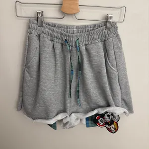 Raw Hem Asymmetrical Shorts with Exposed Pocket Lining thumbnail 1