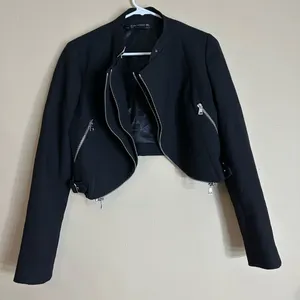 Zara black cropped biker jacket featuring zipper details and side buckle strap thumbnail 1