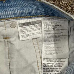 Vintage Levi's 501 light wash distressed jeans. Waist 27 (2" inseam) thumbnail 7