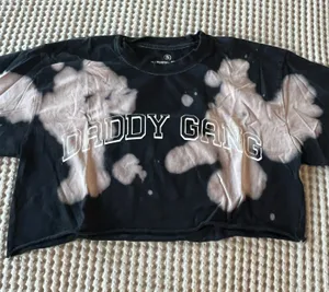 Barstool Daddy Gang black crop tee with bleached tie-dye detailing. Soft cotton feel and bold varsity-style logo. Stylish, easy-to-wear top for everyday play and layering. thumbnail 1