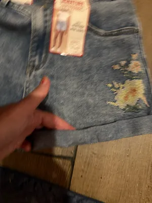 Signature Levi Strauss light blue denim shorts with delicate floral embroidery. Comfortable high-rise fit designed for everyday wear. Soft, faded blue wash that pairs easily with casual tops. Floral detailing adds a feminine touch. thumbnail 7
