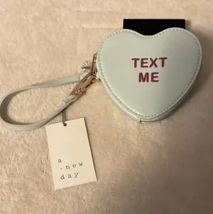 a new day Light Blue Heart Wristlet with Pink "TEXT ME" Detail thumbnail 1