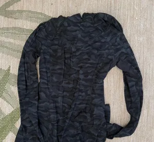 Lululemon black camo jacket Size 4 it also has an opening for a ponytail in the hood. Fantastic condition #athleisure #camouflage #lululemon thumbnail 1