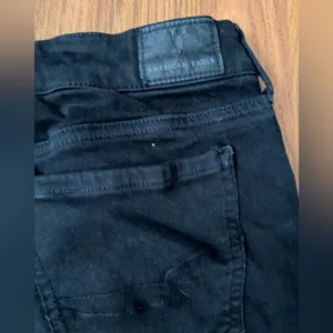 American Eagle Outfitters black distressed mid rise jegging size 8. thumbnail 4