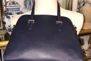 This bag is a Kate Spade Cedar Street Maise satchel in navy blue with gold-tone hardware, made of Saffiano leather, with a top zip closure and top handles. thumbnail 4