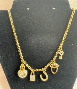 Juicy Couture Gold Tone Charm Necklace with Heart, Key, Lock, and Horseshoe Pendants thumbnail 1