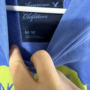 S240. American Eagle blue hoodie with yellow graphic Size M thumbnail 2