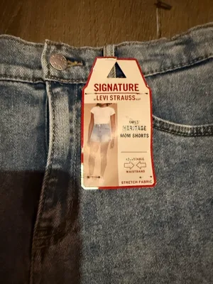 Signature Levi Strauss light blue denim shorts with delicate floral embroidery. Comfortable high-rise fit designed for everyday wear. Soft, faded blue wash that pairs easily with casual tops. Floral detailing adds a feminine touch. thumbnail 5