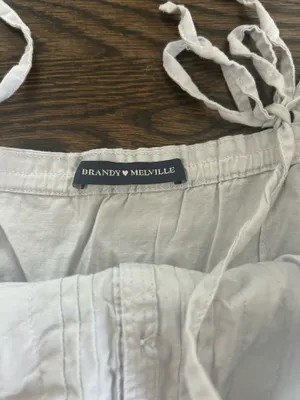 Baby blue Brandy Melville Maeve lace cami top with button-up front and ruffled hem thumbnail 3