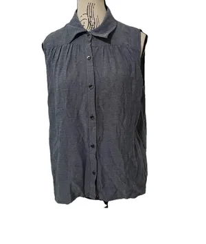 The Cabi Chambray Sleeveless Blouse in blue is a stylish and versatile top perfect for summer, fall, or spring. With a collared neckline, button closure, and ruffle accents, this high-low shirt features a cutout back for added interest. thumbnail 3