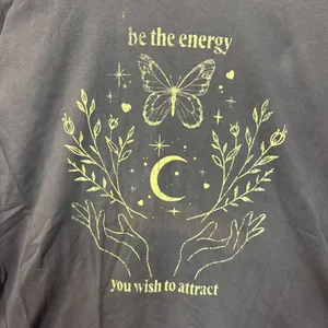 Be the energy you wish to attract T-shirt size O/S. thumbnail 2