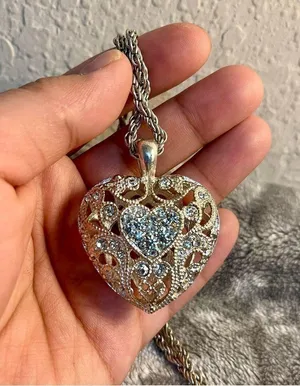 Silver colored heart locket necklace filled with rhinestones in the front side thumbnail 5