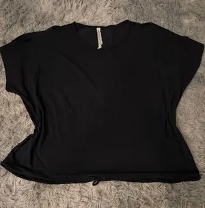 lululemon athletica Black Short Sleeve Drawstring Hem open shoulder Tee thumbnail 1