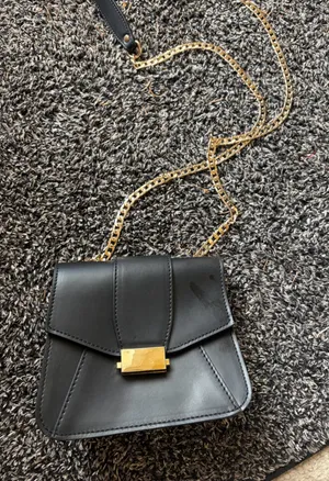 Elegant Black Leather Bag with Gold Accents thumbnail 1
