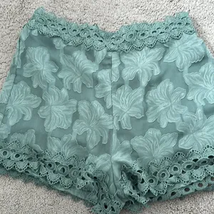 Sage green dressy shorts with lace trim thumbnail 1
