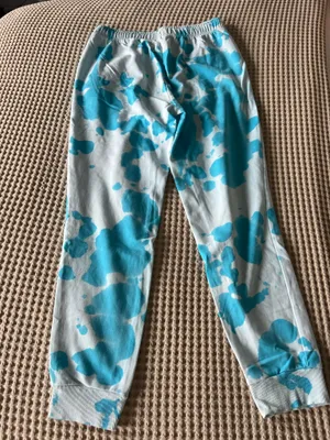 Comfortable aqua and white tie-dye joggers. Elastic waistband with drawstring for a secure fit. Side pockets and ribbed cuffs for everyday wear. Soft fabric keeps relaxed and stylish in aqua pattern. thumbnail 1