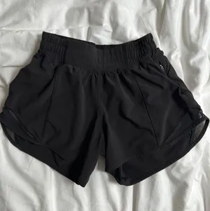 black lululemon high rise 4 inch hotty hot shorts thumbnail 1