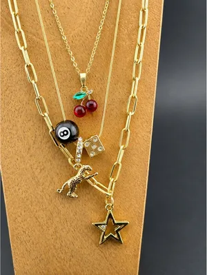 Set of 3 Gold Tone Charm Necklaces with Star, Dinosaur, Dice thumbnail 2