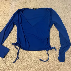 Ambiance Apparel Royal blue wrap top- with side cut outs thumbnail 1
