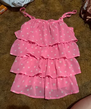 Lightweight pink tank with white polka dots. Features layered ruffle tiers and thin adjustable straps. Flows and feminine silhouette. Great for warm-weather styling. thumbnail 1