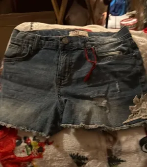 Stylish blue denim shorts with a trendy distressed look. Perfect for casual outings. thumbnail 1