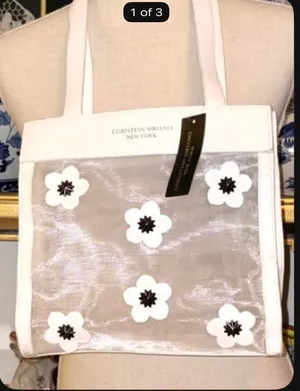 Christian Siriano's elegant translucent mesh tote bag stands out for its delicate black and white floral appliqués. thumbnail 4