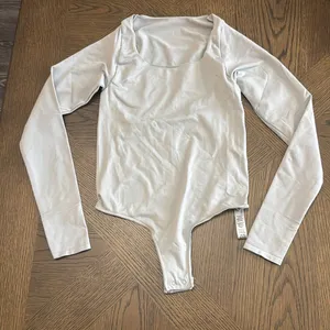 Skims Essential Long Sleeve Scoop Neck Bodysuit, Limited Editionlight Grey,S,$78 thumbnail 8