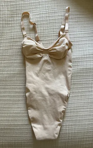 SKIMS Seamless Sculpt Thong Bodysuit in “Sand” thumbnail 1