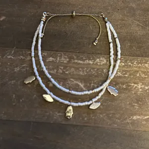 White beaded bolo bracelet with hamsa and evil eye charms thumbnail 5