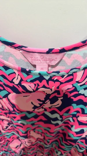 Lilly Pulitzer Romper - Size M Authentic Lilly Pulitzer - Made in China Size: Medium Print: Vibrant abstract in Hot Pink, Navy, Teal / Aqua - Flamingo / shell print - so cute! Style: Sleeveless tank romper, scoop neck, smocked / elastic waist with gold drawstring, shorts bottom show less thumbnail 2
