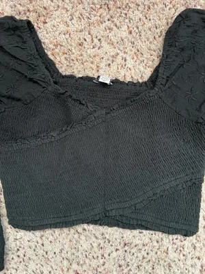 Black smocked crop top featuring dramatic puff sleeves with textured embroidery. Square neckline and fitted bodice create a flattering silhouette. Easy to style for casual or dressed-up looks. American Eagle size medium thumbnail 4