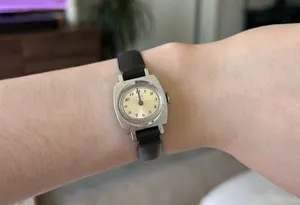 1970s silver vintage Timex women's mechanical winding watch featuring a cushion-shaped case and a leather band thumbnail 1