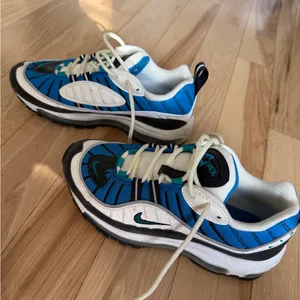 Nike Women's Air Max 98 sneakers in the Blue Nebula/Radiant Emerald colorway. thumbnail 1