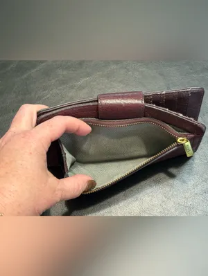 Fossil pebbled leather tab clutch wallet in a deep burgundy or berry color thumbnail 6
