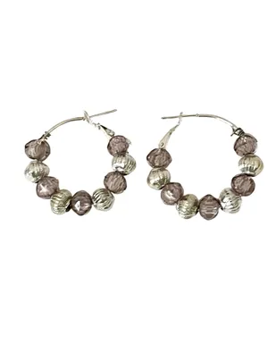 These handmade beaded hoop earrings feature a unique combination of purple, gray, and silver tones. The faceted beads add a touch of bohemian style, making them a perfect gift for someone who loves one-of-a-kind accessories. The handmade quality adds a personal touch to these earrings, making them a standout piece for any jewelry collection. thumbnail 3
