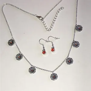 Silver Tone Floral Disc Necklace & Orange Accent Earrings Set thumbnail 1