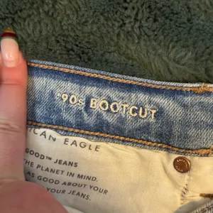 American Eagle blue 90s bootcut jeans with distressed details thumbnail 3