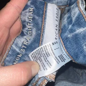American Eagle light wash destroyed relaxed mom jeans thumbnail 2
