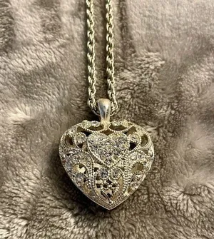 Silver colored heart locket necklace filled with rhinestones in the front side thumbnail 2