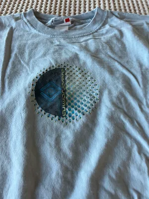 Soft light blue t-shirt. Small circular graphic at chest with teal and navy accents. Casual crew neck style. Easy staple for everyday wear. thumbnail 2