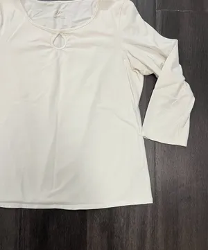 Soft cream long sleeve top with a modest scoop neckline. Features a small decorative ring keyhole at center front. Lightweight, easy to layer for casual or office wear. Simple, clean silhouette for versatile styling. J, Jill size medium. 95% cotton 5% spandex thumbnail 4