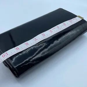 Black faux patent leather clutch with wave design on front. thumbnail 7