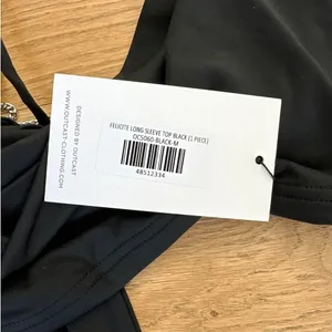 Outcast Clothing - Felicite Long Sleeve Tie Back Top in Black thumbnail 2