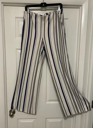 CHICO’S Stylish wide-leg pants in a navy and white striped pattern. Lightweight, flowy fabric for all-day comfort. Versatile design that dresses up or down. Easy to pair with tops and sandals. thumbnail 1